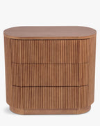 Commode élégante en bois avec coins arrondis, façade nervurée et système d'ouverture-pression pour chambre et salon