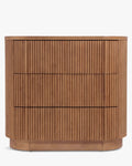 Commode élégante en bois avec coins arrondis, façade nervurée et système d'ouverture-pression pour chambre et salon